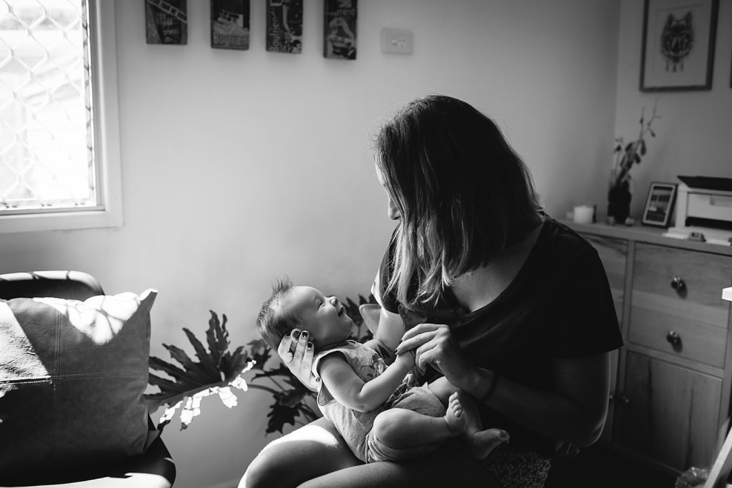 Mother holding her baby at home
