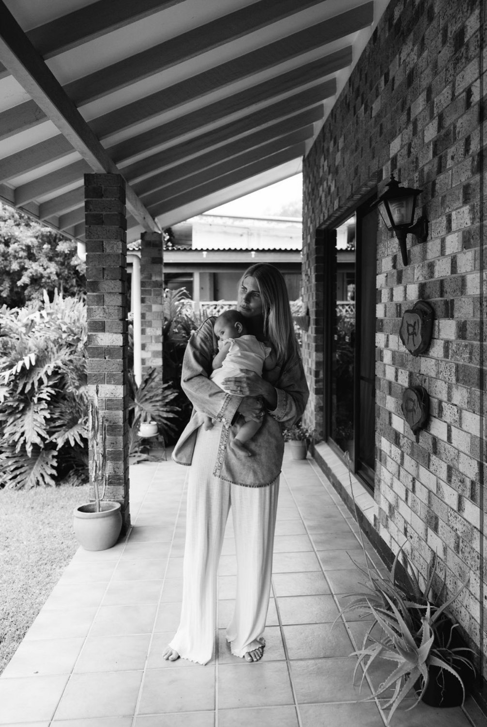 Mother holding her baby at home, postnatal recovery on the Gold Coast